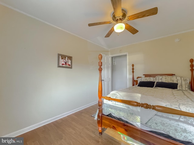 bedroom featuring light wood-type flooring, ceiling fan, and crown molding