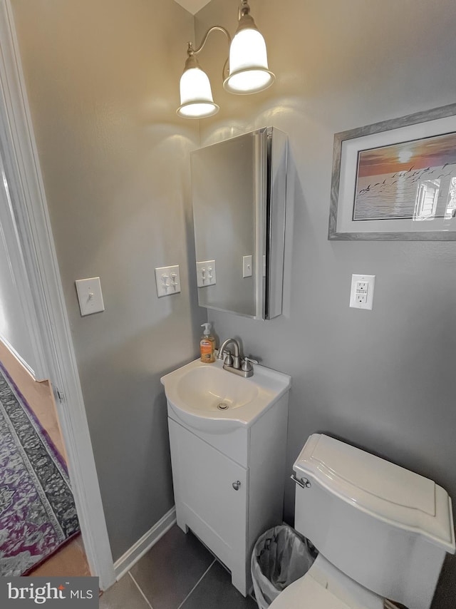 bathroom with tile patterned flooring, vanity, and toilet