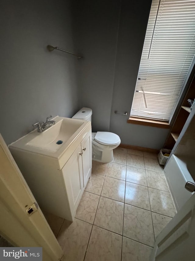 bathroom with tile patterned floors, vanity, and toilet