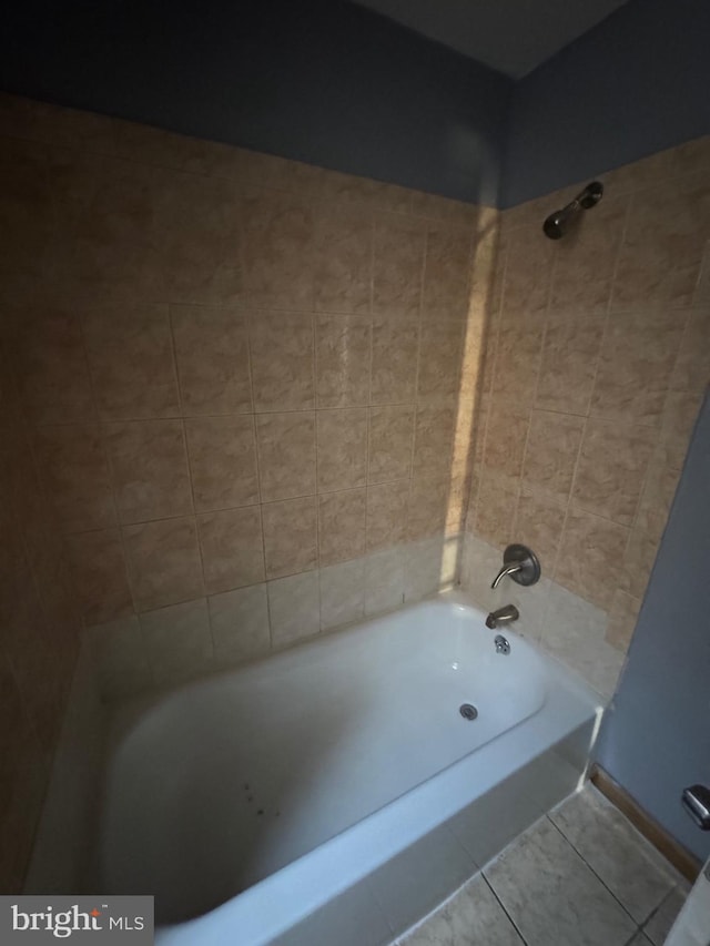 bathroom with tile patterned floors and tiled shower / bath combo