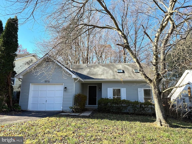 view of front of home with a garage and a front lawn