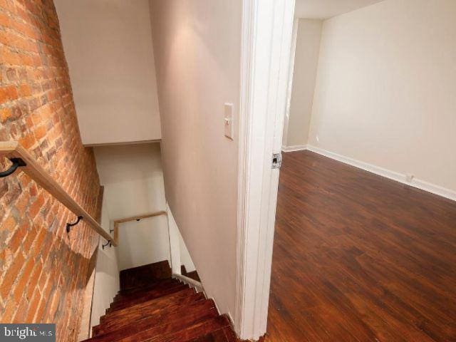 stairs featuring wood-type flooring