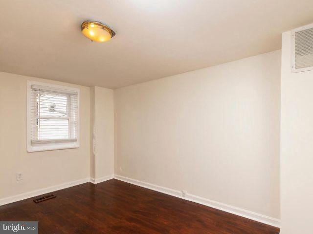 spare room featuring dark hardwood / wood-style flooring