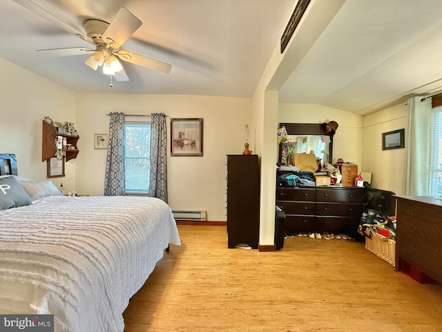 bedroom featuring ceiling fan, a baseboard radiator, lofted ceiling, and light hardwood / wood-style floors