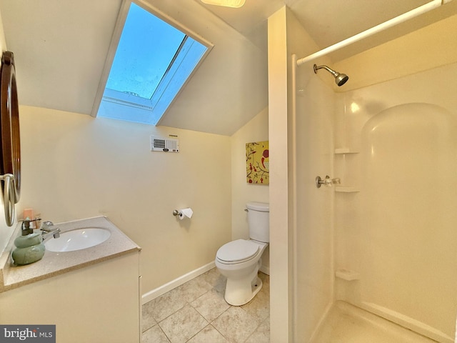 bathroom featuring a skylight, vanity, a shower, tile patterned flooring, and toilet