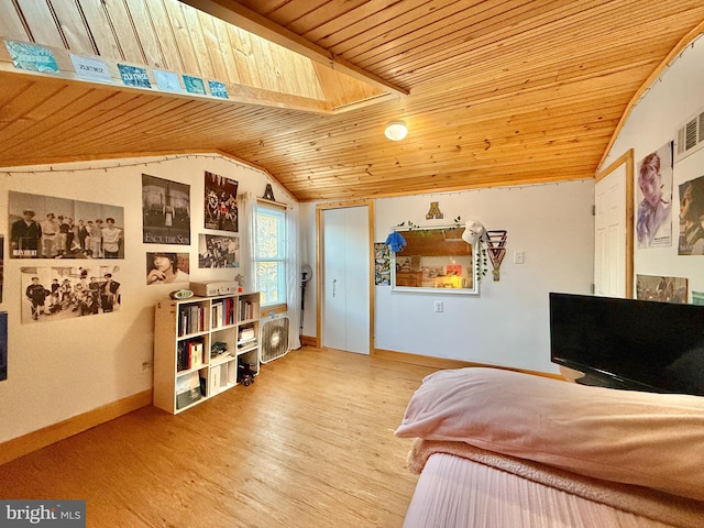 bedroom with wood ceiling, vaulted ceiling with skylight, and hardwood / wood-style floors