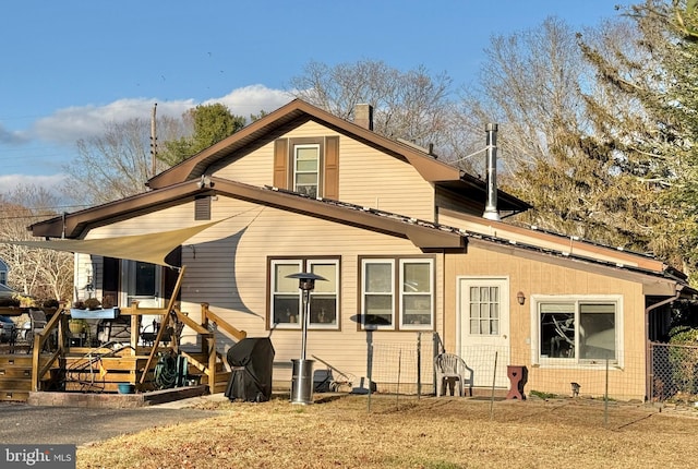 back of house featuring a wooden deck