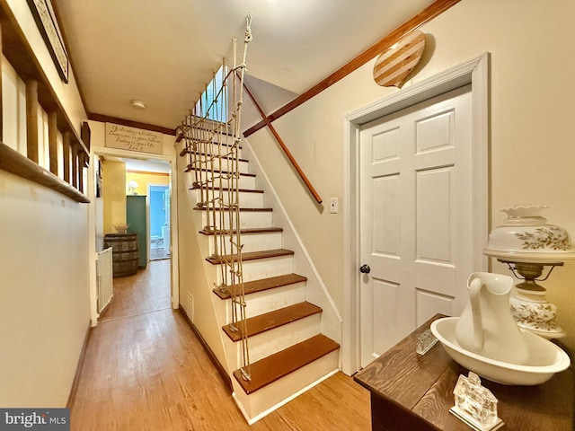 stairs featuring hardwood / wood-style flooring