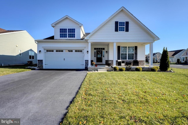 view of front of house featuring a front yard, a garage, and a porch