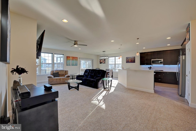 carpeted living room featuring ceiling fan