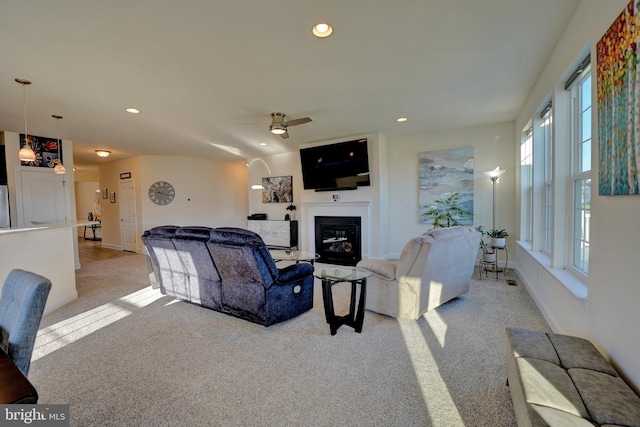 carpeted living room with ceiling fan