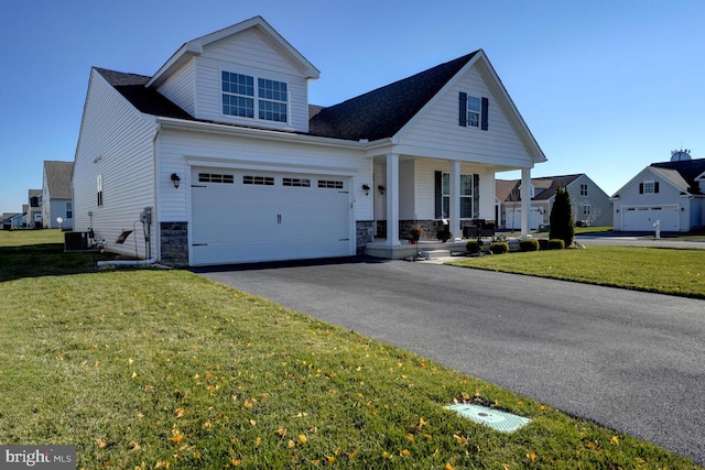 view of front of property featuring a front lawn, covered porch, and central AC