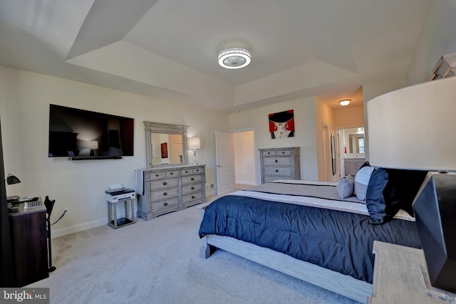 carpeted bedroom with a raised ceiling