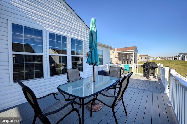 deck featuring a grill and a sunroom