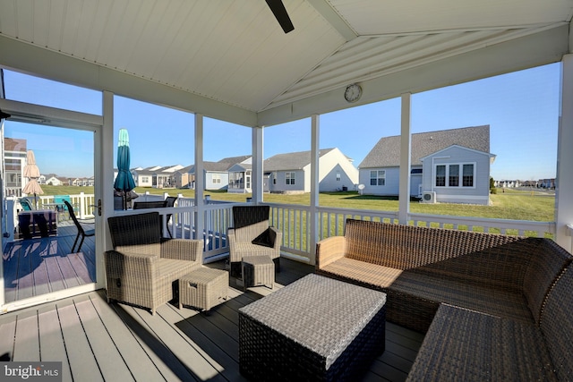 sunroom with lofted ceiling and a healthy amount of sunlight