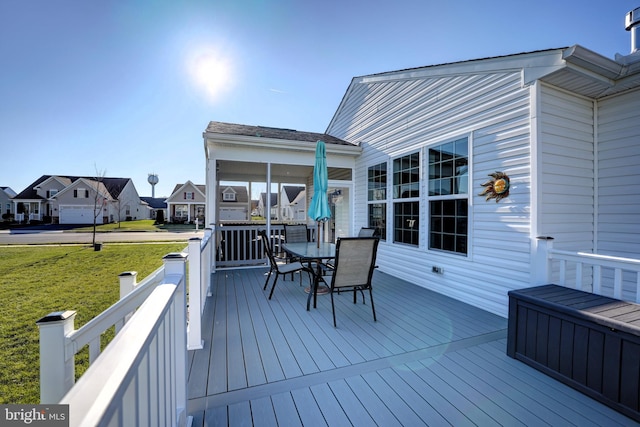 wooden terrace featuring a yard