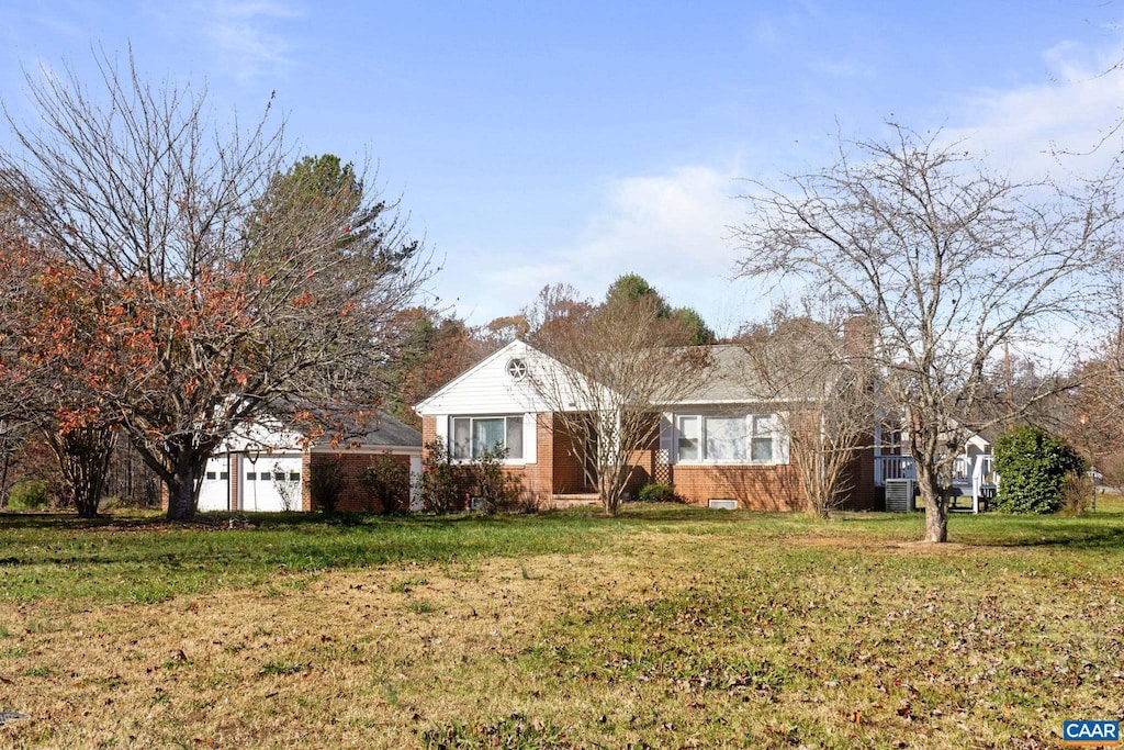 single story home featuring a front yard and a garage