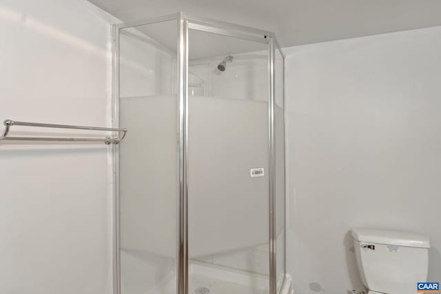 bathroom featuring toilet and walk in shower