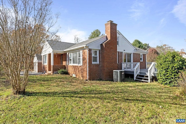 view of property exterior with central air condition unit, a wooden deck, and a lawn