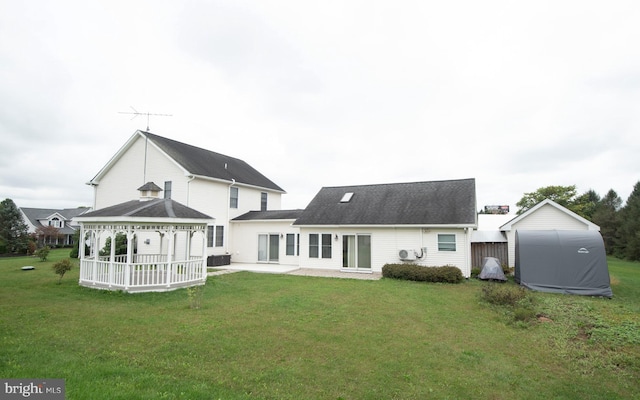 back of property featuring a gazebo, a yard, and a patio