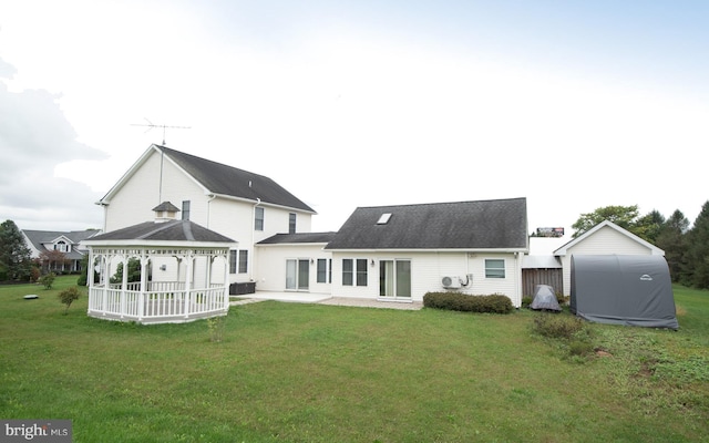 back of house with a gazebo, a patio area, and a lawn