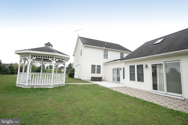 rear view of house with a gazebo, a patio, a lawn, and central AC