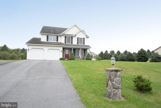 view of front facade with a front yard and a garage