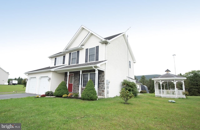 view of front of house with a gazebo, a front yard, and a garage