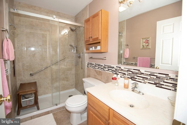 bathroom featuring vanity, tile patterned floors, toilet, tile walls, and an enclosed shower