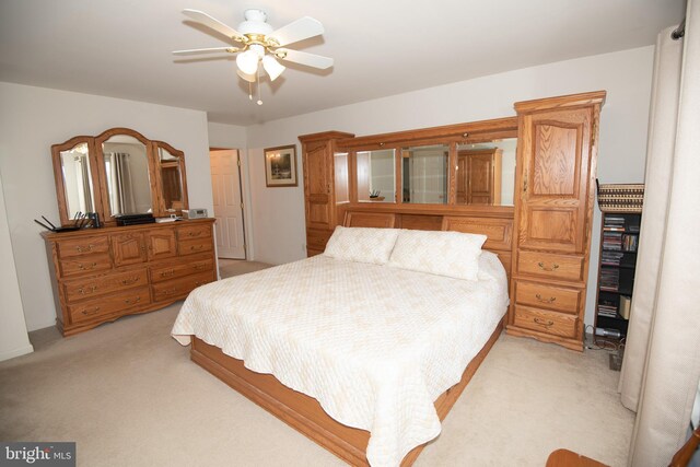 bedroom with ceiling fan and light colored carpet