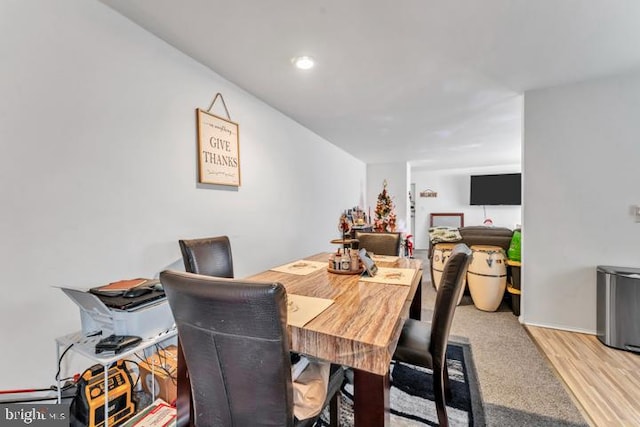 dining space with light hardwood / wood-style flooring