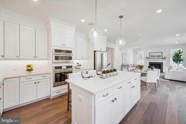 LOT16-CARLISLEAZALEA Bellflower Ln, Newtown Square, PA 19073 - kitchen featuring appliances with stainless steel finishes, dark wood-type flooring, recessed lighting, white cabinets, and a kitchen island