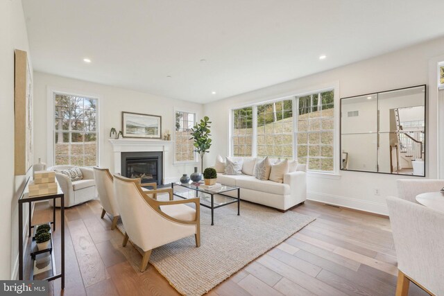 LOT16-CARLISLEAZALEA Bellflower Ln, Newtown Square, PA 19073 - living area featuring hardwood / wood-style flooring, a glass covered fireplace, baseboards, recessed lighting, and stairs