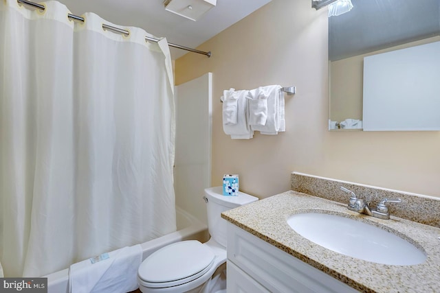 full bathroom with vanity, toilet, and shower / tub combo with curtain