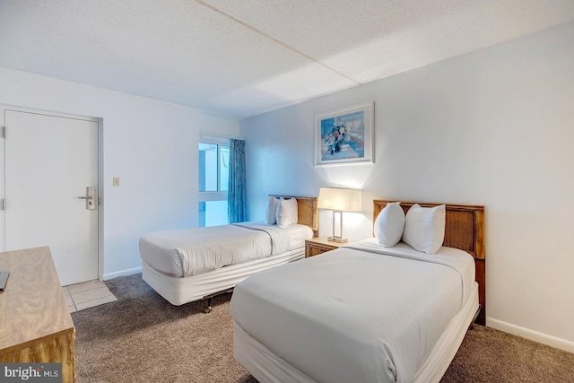 bedroom with carpet flooring and a textured ceiling