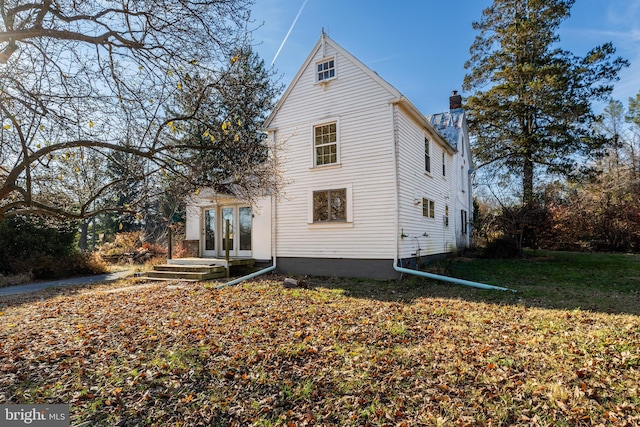 exterior space with a lawn and french doors