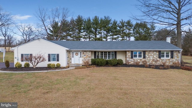 ranch-style home with a front lawn