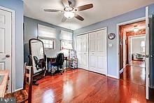 office space with ceiling fan and dark wood-type flooring