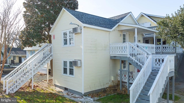 view of side of home featuring a wall mounted AC