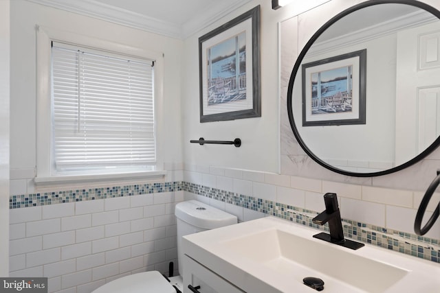 bathroom featuring vanity, toilet, tile walls, and crown molding