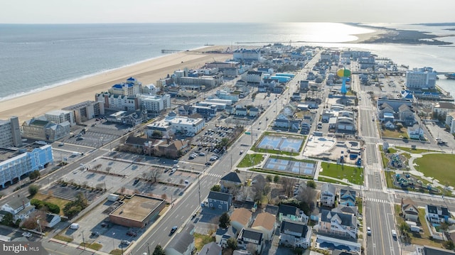 bird's eye view featuring a water view and a beach view