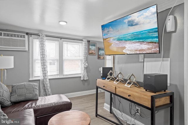 home office with a wall unit AC, light hardwood / wood-style flooring, and ornamental molding