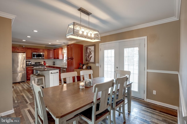 dining space featuring plenty of natural light, wood-type flooring, sink, and french doors