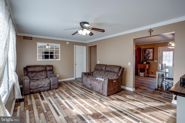 living room with light wood-type flooring, ceiling fan, and crown molding