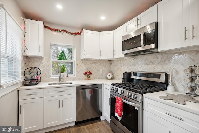 kitchen with white cabinets, sink, and stainless steel appliances