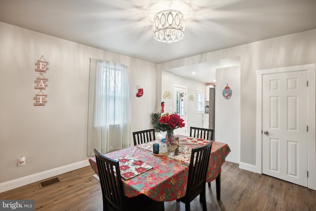 dining room with an inviting chandelier and hardwood / wood-style flooring