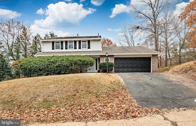 front facade with a front lawn and a garage