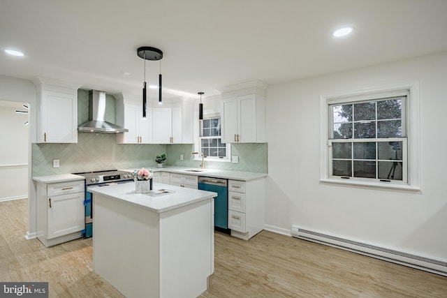 kitchen with white cabinetry, wall chimney exhaust hood, stainless steel appliances, a baseboard heating unit, and decorative light fixtures