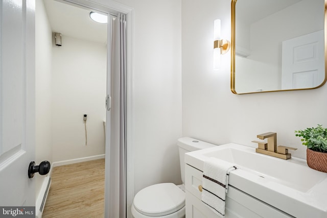 bathroom featuring vanity, wood-type flooring, and toilet