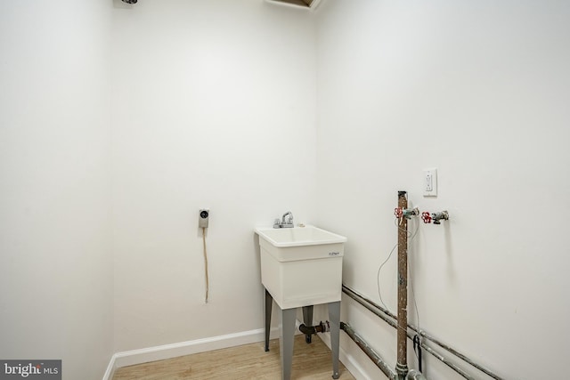 washroom featuring light hardwood / wood-style floors and hookup for a washing machine